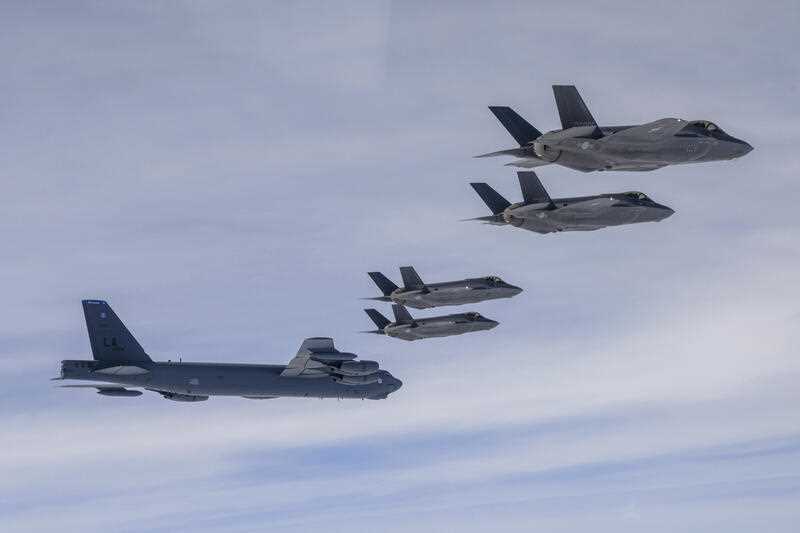 a U.S. B-52H bomber, left bottom, and South Korean Air Force F-35A fighter jets fly over the Korean Peninsula during a joint air drill in South Korea, Friday, April 14, 2023