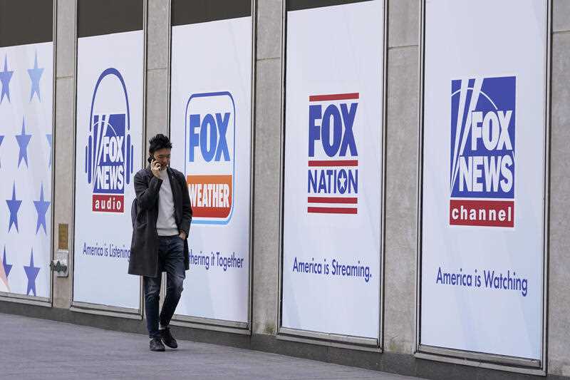 A man walks past the News Corp. and Fox News headquarters on April 19, 2023, in New York