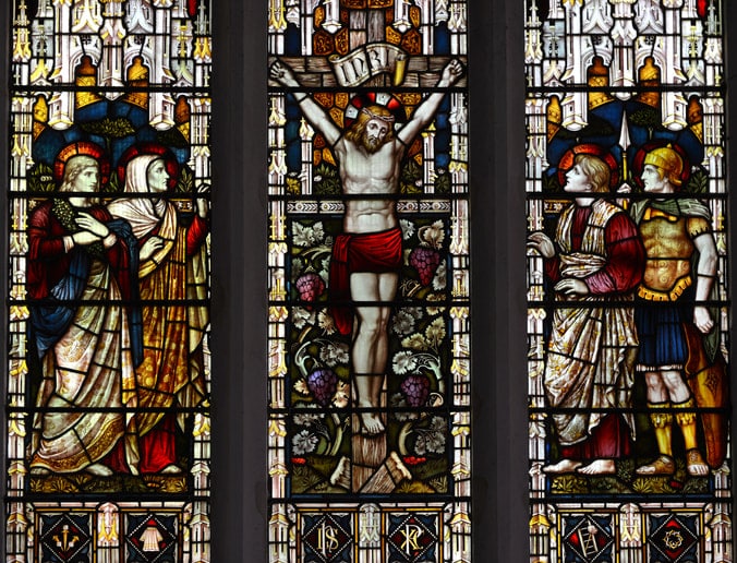 stained glass window in Christian church depicting the crucifixion of Jesus Christ.