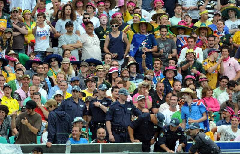 police among a colourful crowd at a cricket test match between Australia and Pakistan in Sydney