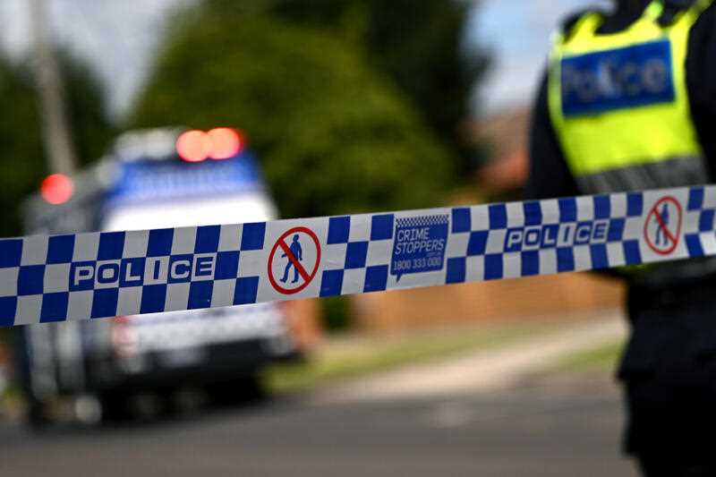 Victoria Police tape restricts access to a road