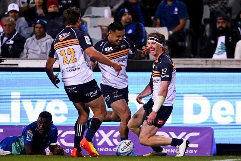 Ben O’Donnell of the Brumbies celebrates with team mates after scoring a try during the Super Rugby Pacific Round 8 match between the ACT Brumbies and the Fijian Drua at GIO Stadium in Canberra, Friday, April 14, 202