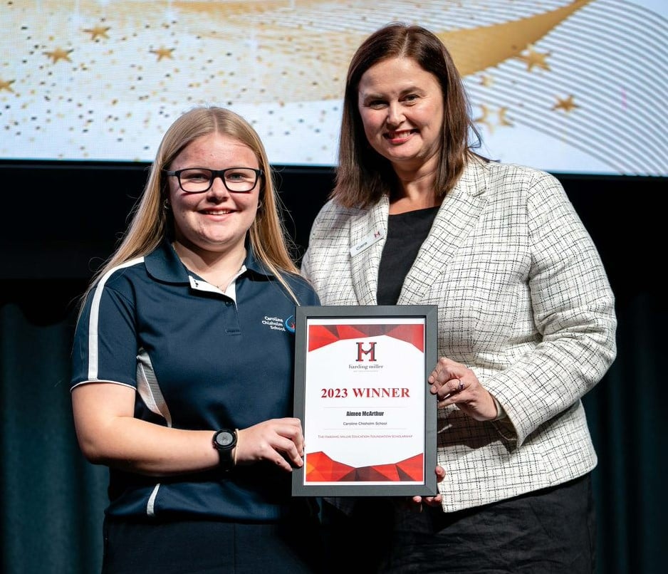 Year 9 female student accepting an award from female executive