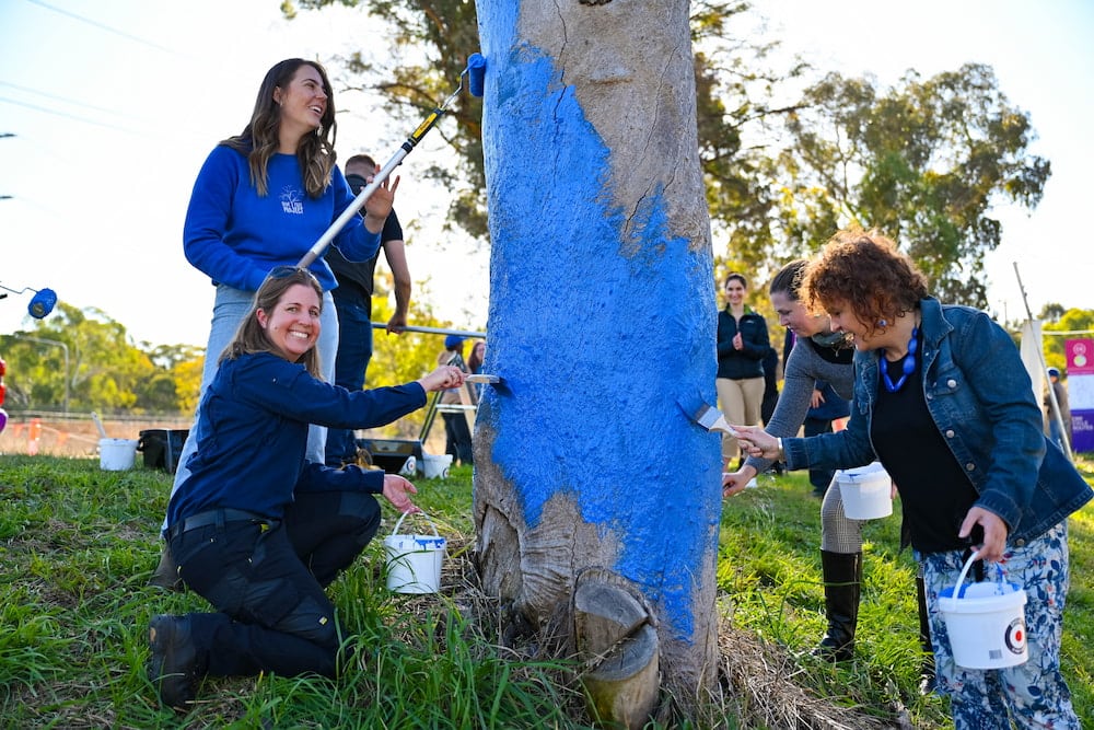 Painting the blue tree in Lyons. Photo supplied