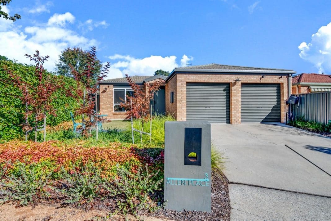 neat, yellow brick Canberra home with charcoal trim