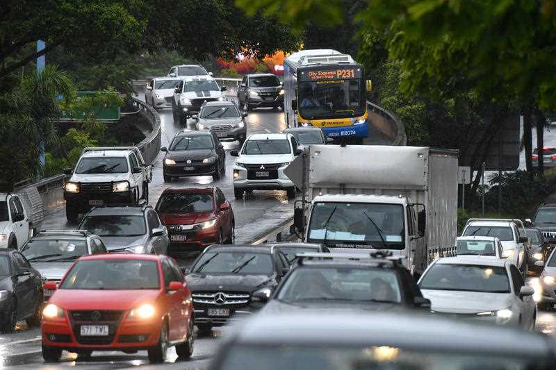 Peak hour traffic is seen as rain falls over Brisbane