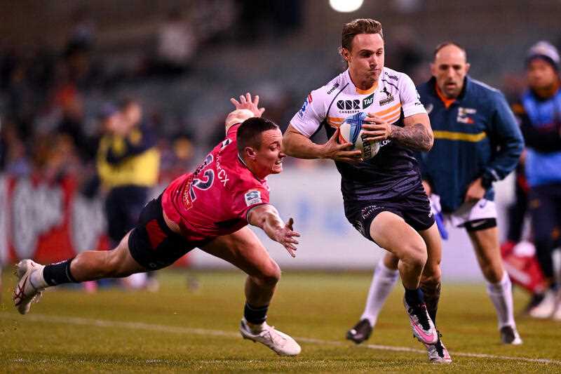 Corey Toole of the Brumbies makes a break to score a try during the Super Rugby Pacific Round 15 match between the ACT Brumbies and the Melbourne Rebels at GIO Stadium in Canberra, Friday, June 2, 2023