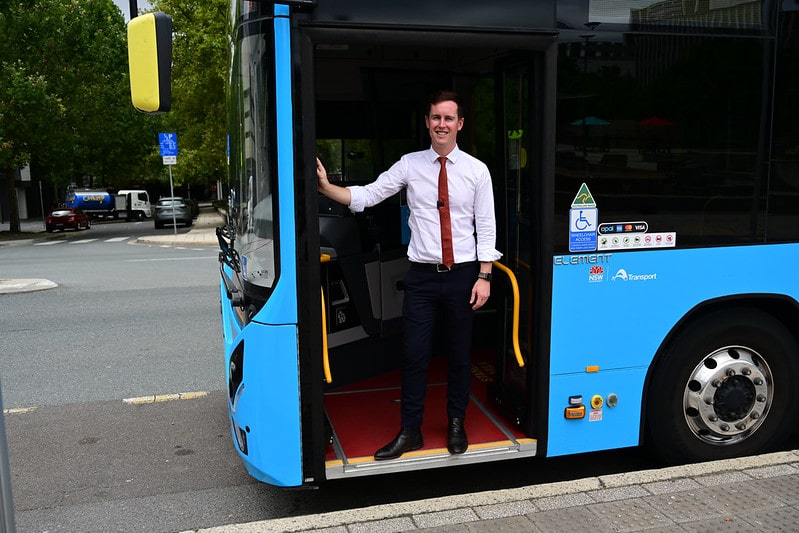 Chris Steel MLA and a bus. File photo
