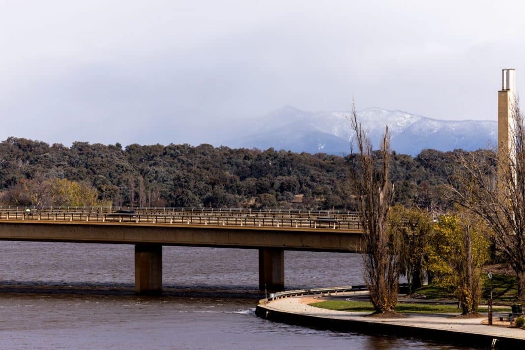 looking across Lake Burley Griffin in Canberra to snow on the Brindabella mountains in the distance