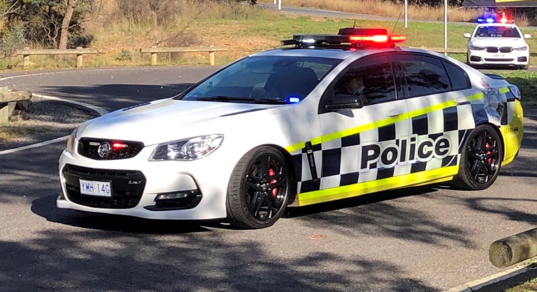 ACT police car with flashing red light on top