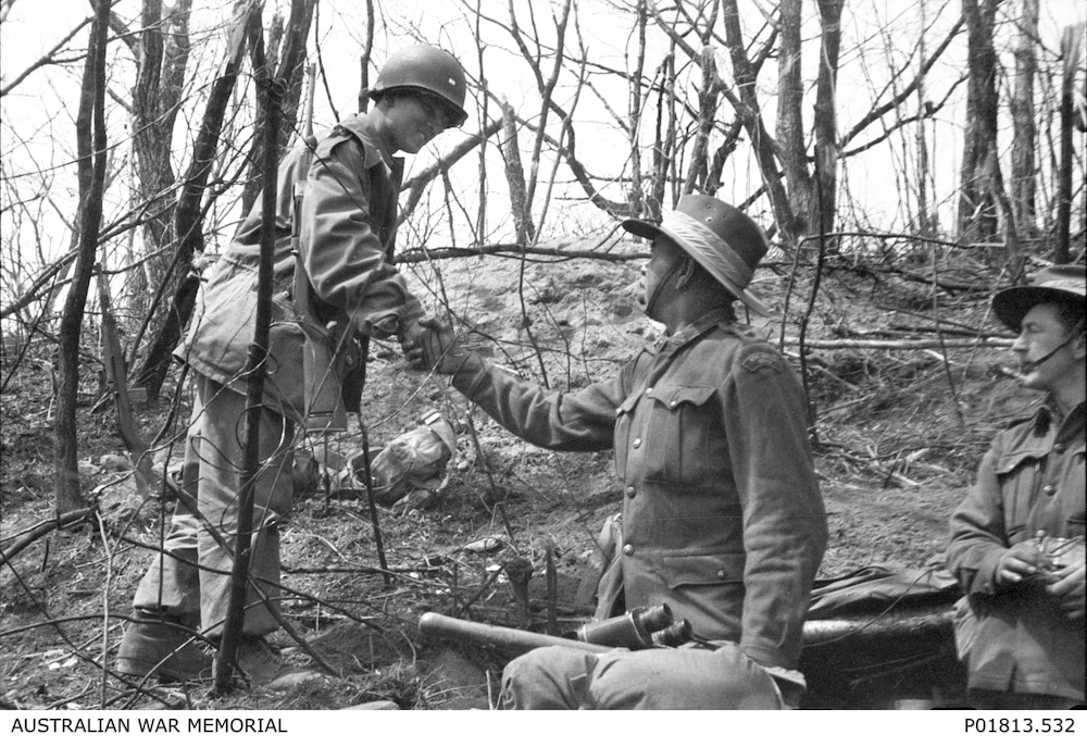 Captain Reg Saunders (right), commander of C Company, 3rd Battalion, The Royal Australian Regiment (3RAR), shakes hands with a Korean soldier. Captain Saunders was the first Aboriginal serviceman to command a rifle company. Photo: Australian War Memorial