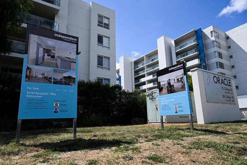 ‘For Sale’ signs are seen outside an apartment block in Canberra