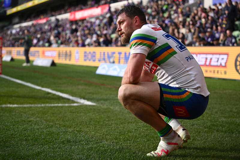 Elliott Whitehead of the Raiders reacts as Storm players celebrate a try during the NRL Round 24 match between the Melbourne Storm and the Canberra Raiders at AAMI Park in Melbourne, Sunday, August 13, 2023