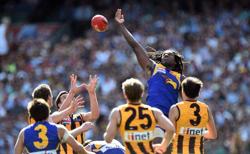 West Coast Eagles player Nic Natanui hits the ball out against the Hawthorn Hawks during the AFL Grand Final at the MCG, Saturday, Oct. 3, 2015.