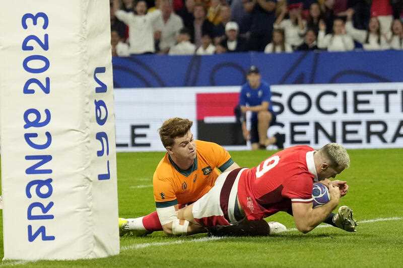 Wales' Gareth Davies scores the opening try during the Rugby World Cup Pool C match between Wales and Australia at the OL Stadium in Lyon, France, Sunday, Sept. 24, 2023
