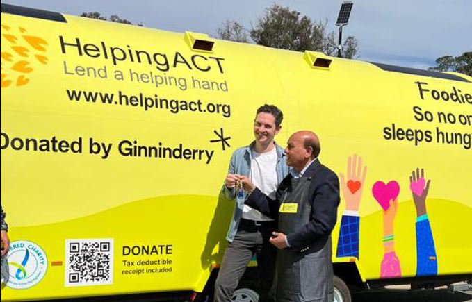 HelpingACT founder Mohammed Ali (right) and Ginninderry's Marcus Mills-Smith admire the new food trailer. Photo: HelpingACT
