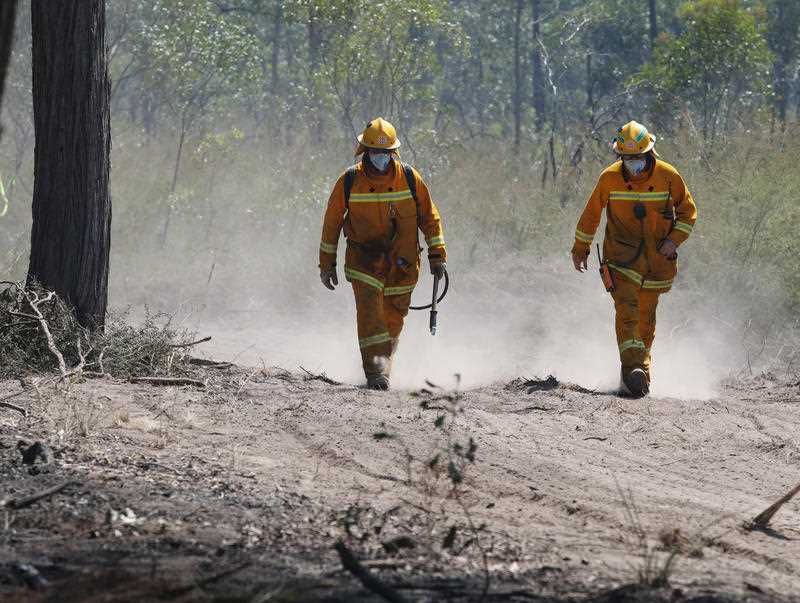 Victoria's Country Fire Authority fire fighters work to mop out hot spots from back burns