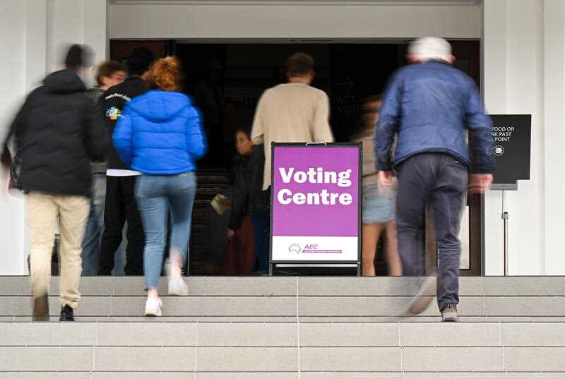 People walk into the voting centre at Old Parliament House in Canberra, Saturday, October 14, 2023
