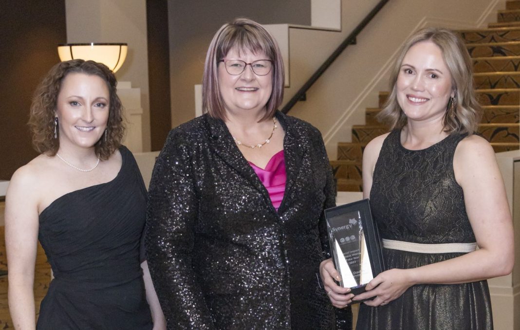 3 business women in formal wear at awards night