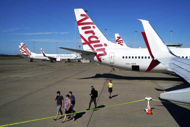 Passengers prepare to board a Virgin Australia flight bound for Darwin at Brisbane Airport