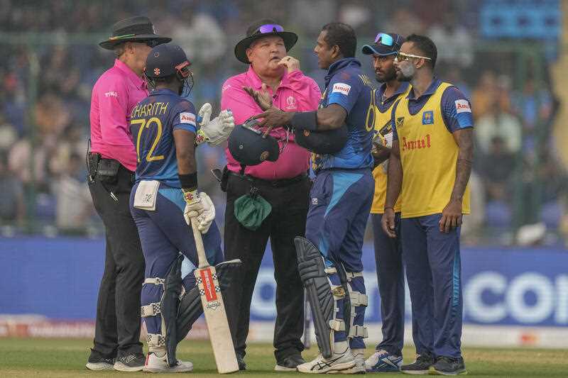 Sri Lanka's Angelo Mathews, third right, talks to umpires after he was declared timed out during the ICC Men's Cricket World Cup match between Bangladesh and Sri Lanka in New Delhi, India