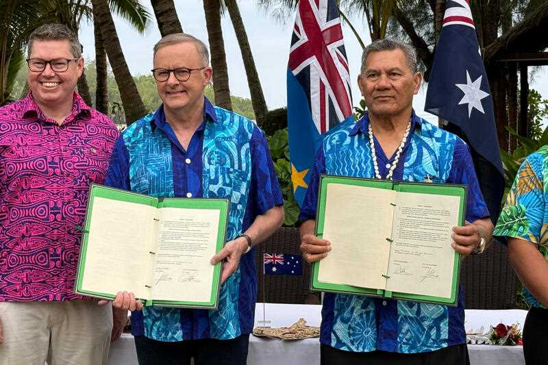 Australian Prime Minister Anthony Albanese and Tuvalu Prime Minister sign a compact between the two nations at the Pacific Resort, Rarotonga, the Cook Islands, Thursday, November 9, 2023.