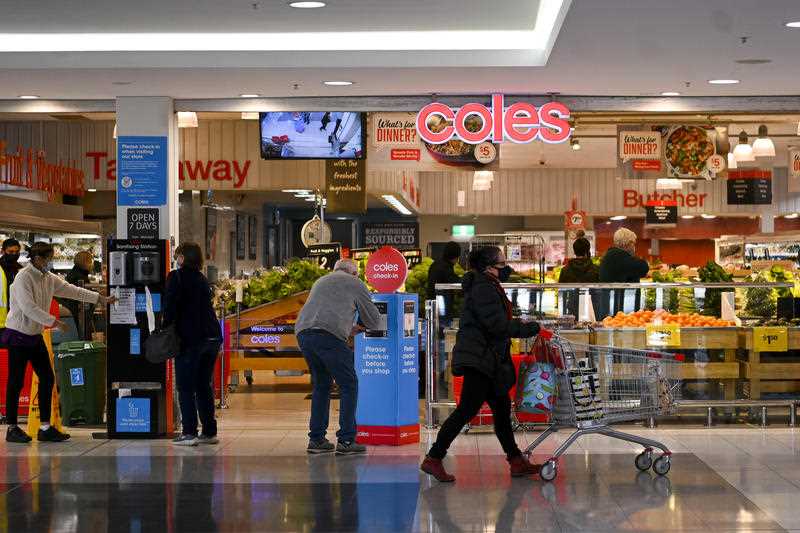 Shoppers walk past at a Coles supermarket in Canberra