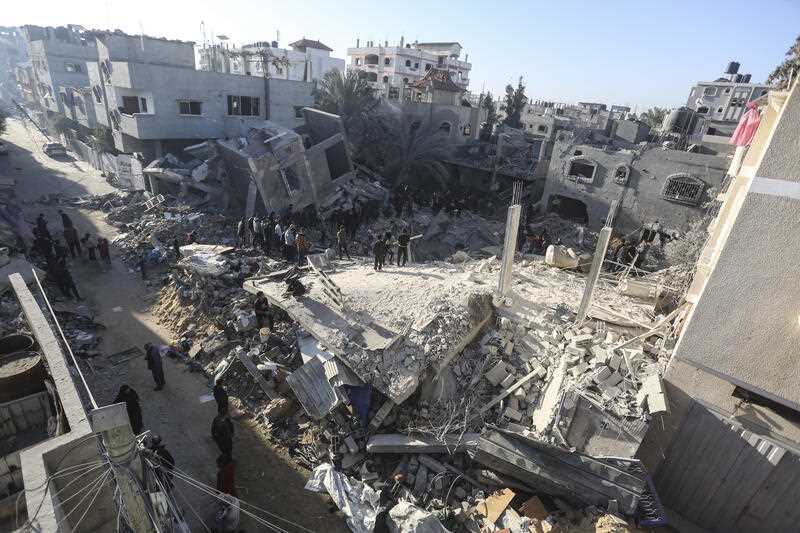 Palestinians look for survivors of the Israeli bombardment of the Gaza Strip in Rafah, Sunday, Dec. 3, 2023