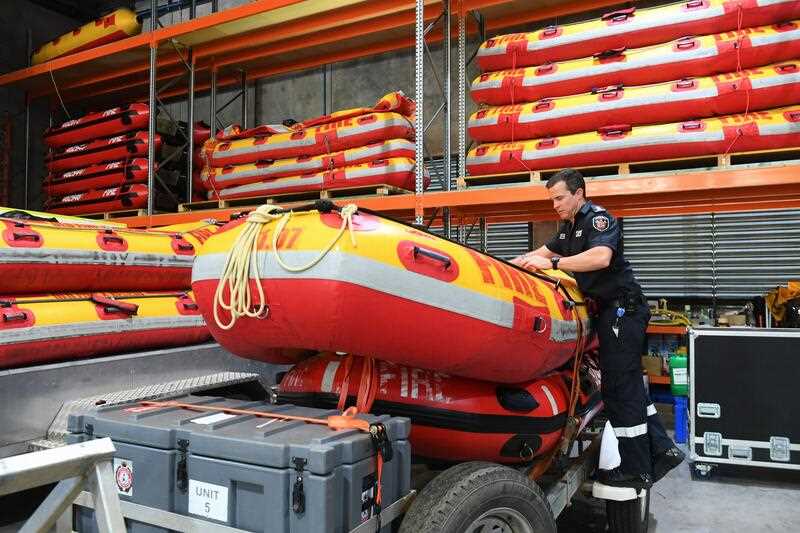 A Fire and Rescue officer prepares swift water rescue boats at a facility in Brisbane, Friday, December 8, 2023.