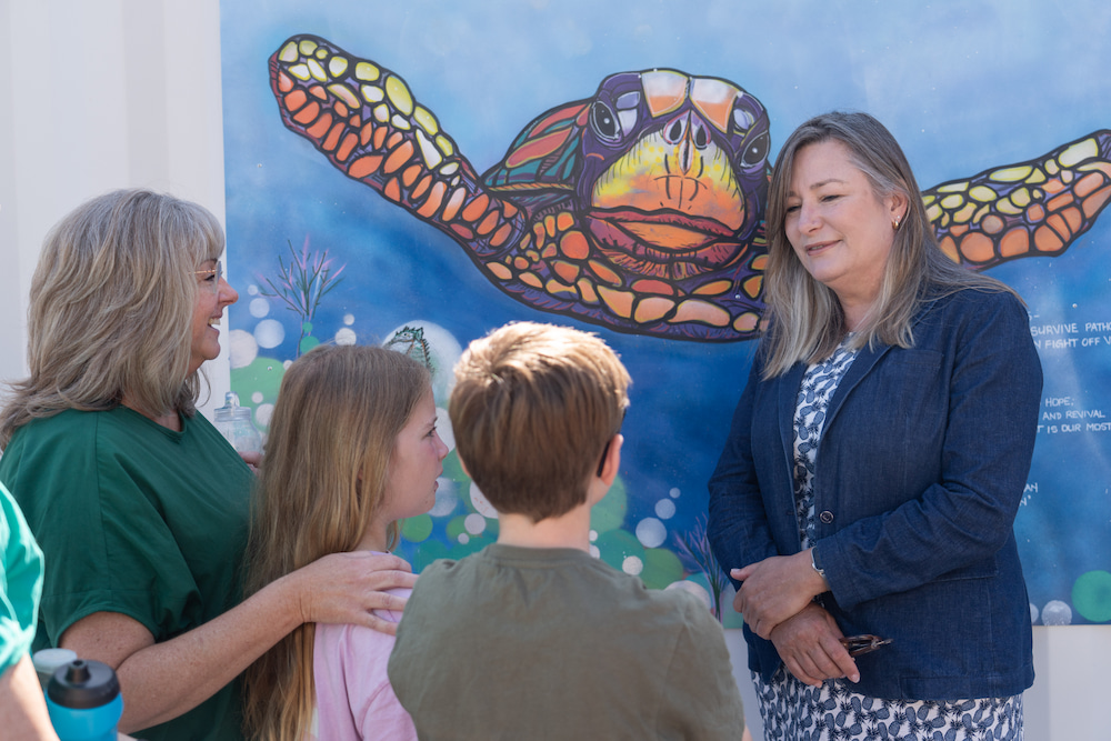 Artist Tracey Hall and her children with Yvette Berry, ACT Minister for Housing and Suburban Development. Photo supplied