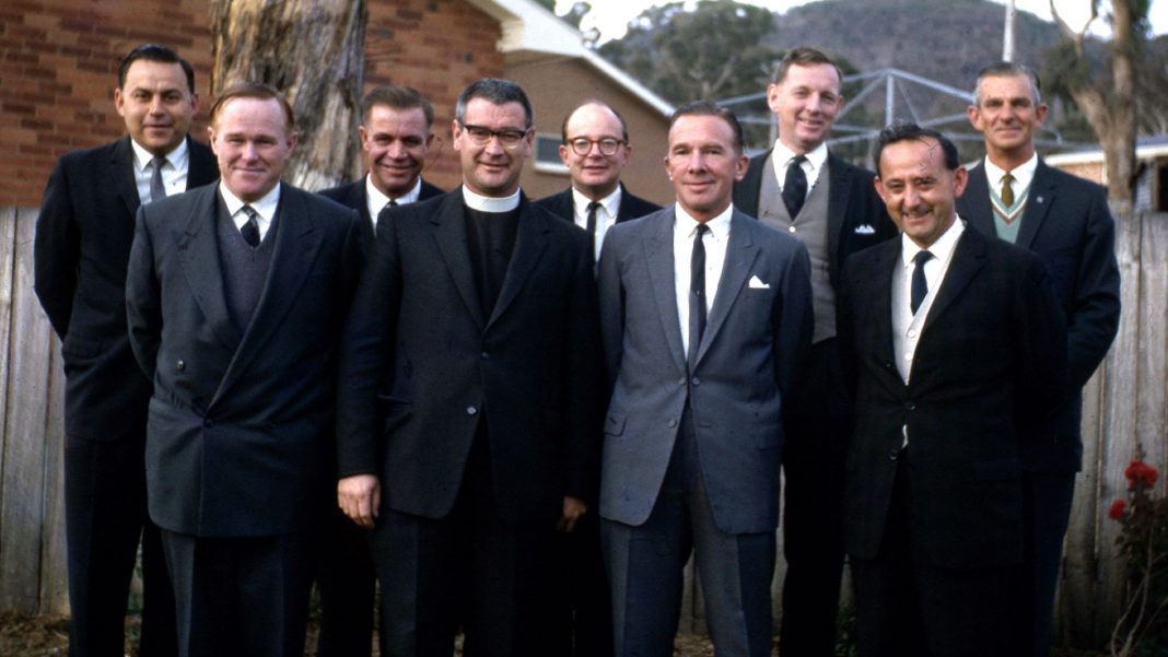Presbyterian minister and eight men in suits pose for photo in Canberra in 1965