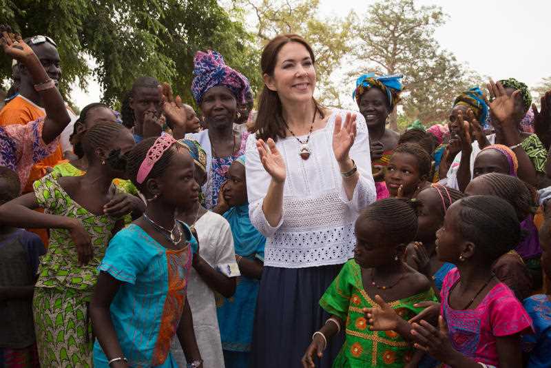 Crown Princess Mary of Denmark greets women and girls of the Sahre Bocar community in the Kaolack region of Senegal