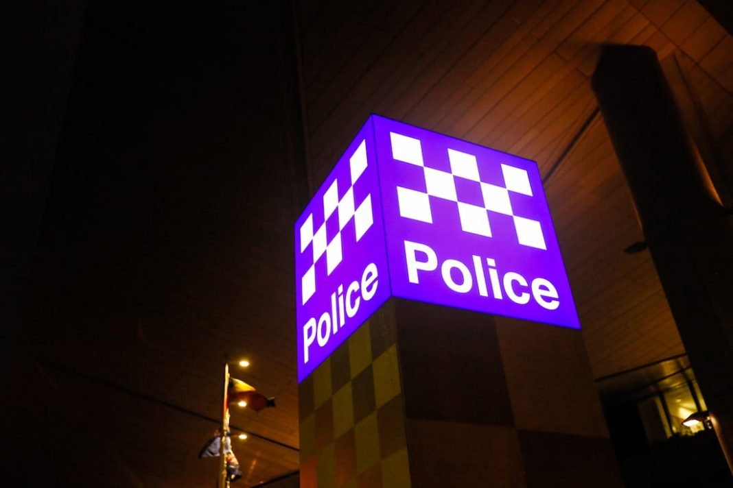 blue police sign at night