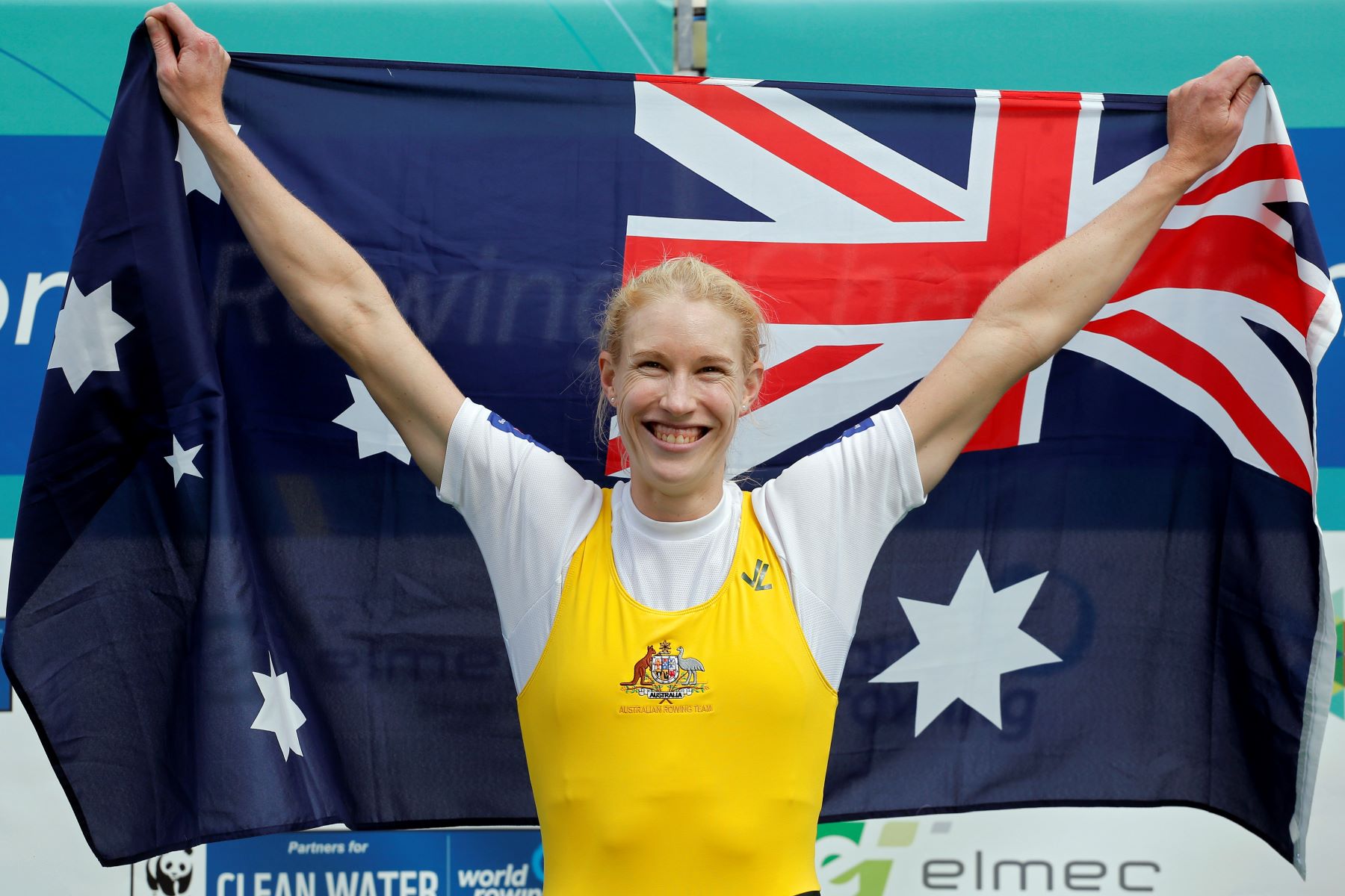 Australian Olympic rower Kim Crow celebrates on the podium after winning the Women's single sculls during the World Rowing Championships in Aiguebelette, France, Sunday, Sept. 6, 2015