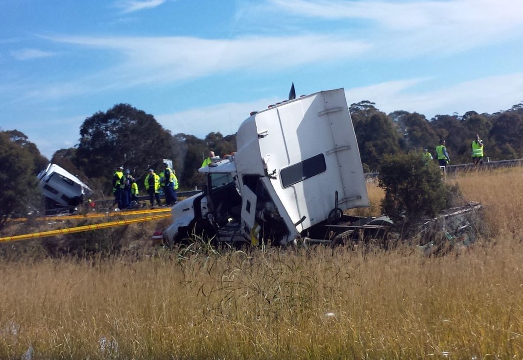 A truck crash on the Hume Highway in Sydney's west. A truck driver has died after three semi-trailers were involved in a crash on the Hume Highway in Sydney's west, on Monday, July 21, 2014.