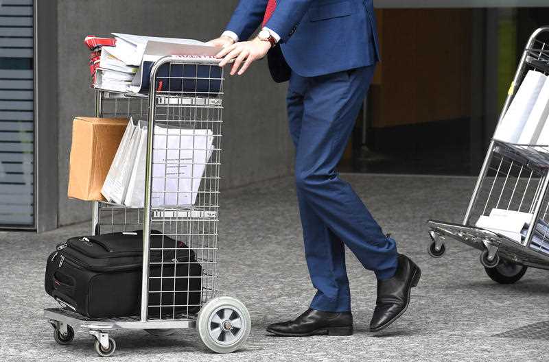 Court documents are wheeled from the Supreme Court in Brisbane