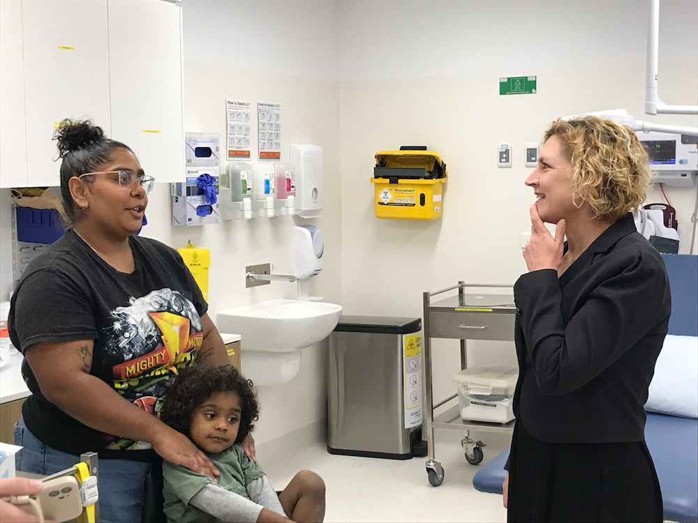 Emma Davidson (right), ACT Minister for Population Health, talks to Yulcaila Hoolihan-Mongta and two-year-old Allamurra at Winnunga Nimmityjah Aboriginal Health Service. Photo: Nicholas Fuller