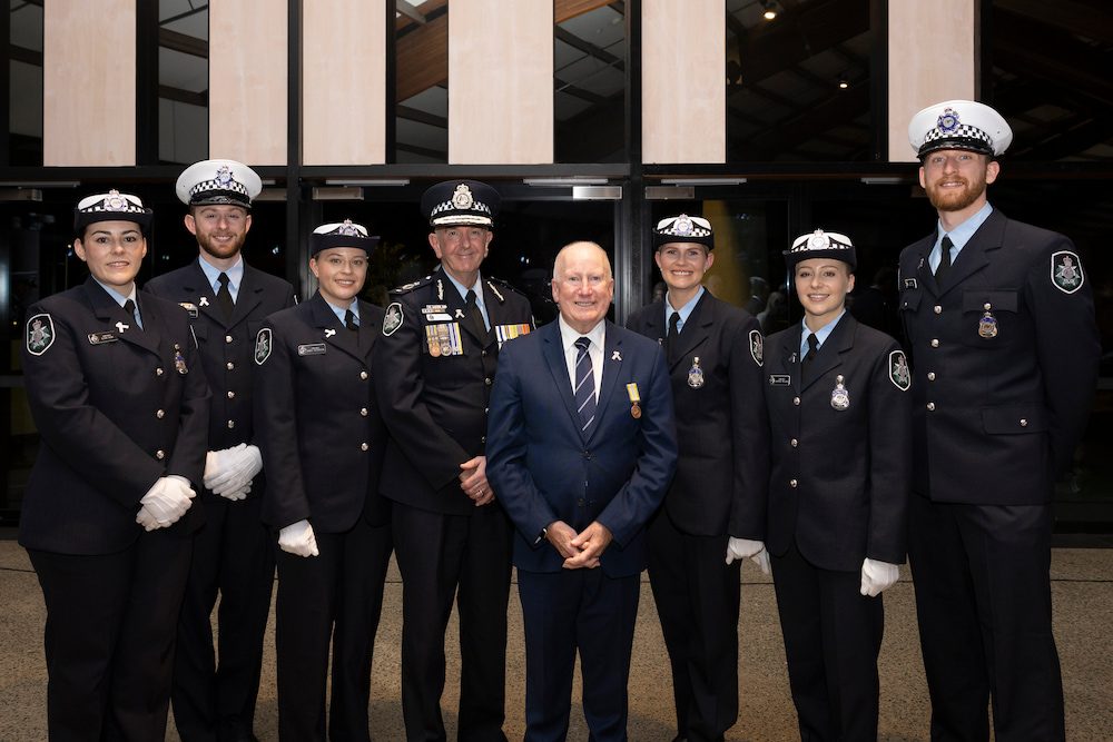 Minister Mick Gentleman and Chief Police Officer Scott Lee with the new recruits, at the graduation ceremony at the National Arboretum. Photo supplied