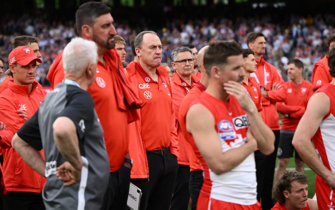 Swans coach John Longmire (centre) watches the presentation after the 2024 grand final. (Joel Carrett/AAP PHOTOS)