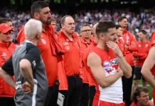 Swans coach John Longmire (centre) watches the presentation after the 2024 grand final. (Joel Carrett/AAP PHOTOS)