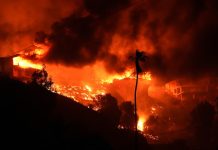 Fierce winds are hindering firefighting efforts and fuelling the fires in California. (AP PHOTO)