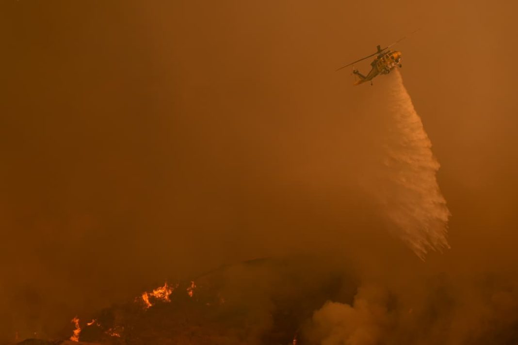 Aircraft dropped water and fire retardant to stem the spread of the Palisades Fire, one of six in LA (AP PHOTO)