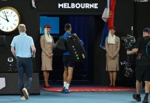 Novak Djokovic leaves court trailed by Jim Courier (left), who he refused to be interviewed by. (James Ross/AAP PHOTOS)